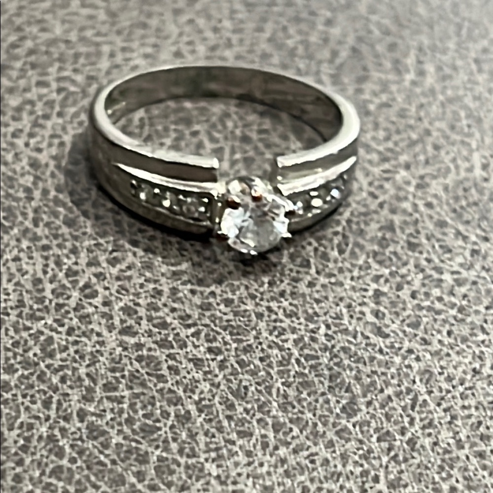 *Elegant Silver and White Solitaire Ring with Accent Stones